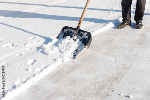 man cleans the snow in the yard