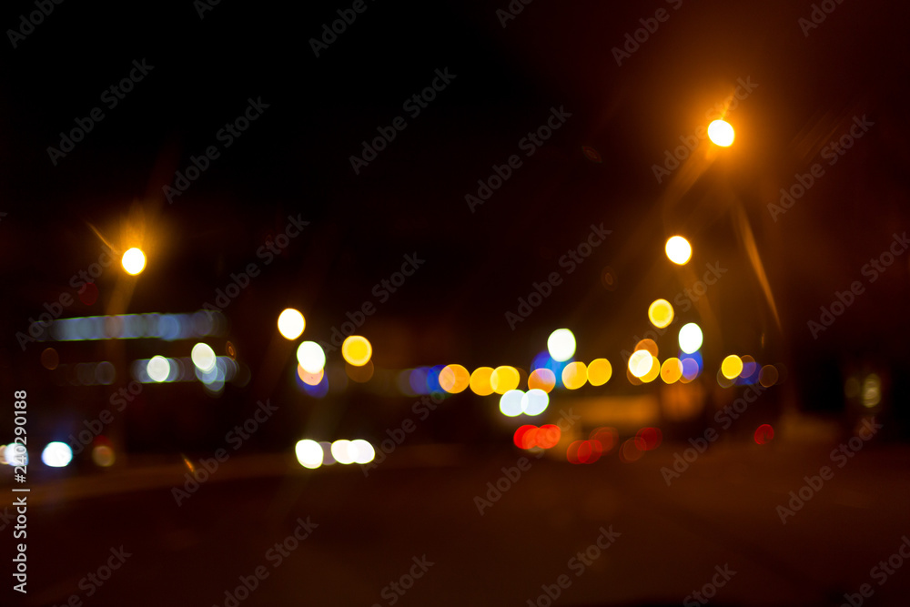 Artistic style - Defocused urban abstract texture ,blurred background with bokeh of city lights from car on street at night, vintage or retro color tone