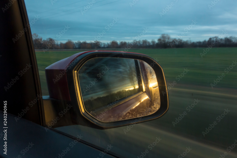 sunset in the rearview mirror of the car sunset in the rearview mirror of the car