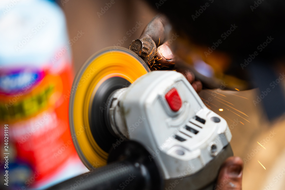 Fototapeta premium Mechanic Reshaping Bolt with Grinder