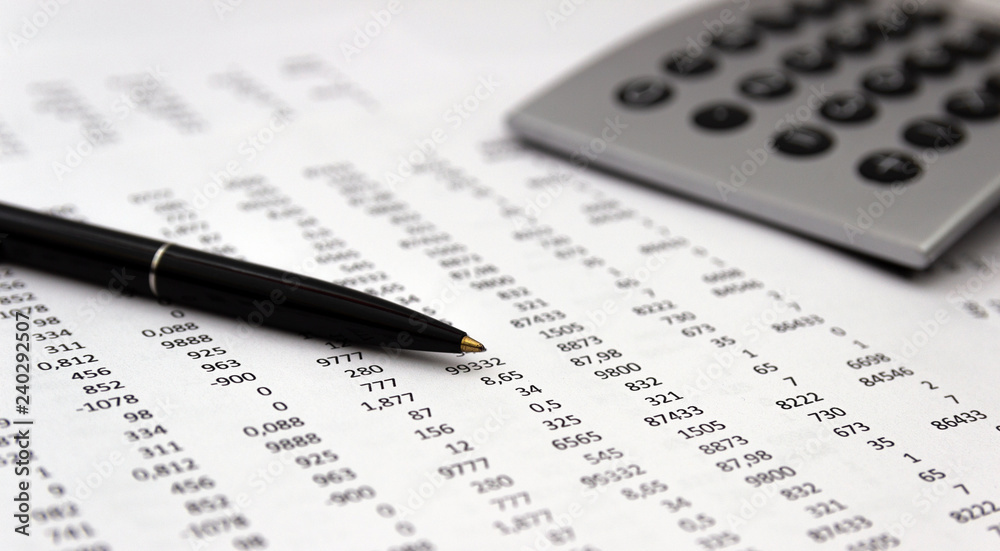 Financial accounting, Image a plurality of numbers on paper and calculator, Numbers on paper, a pen and a calculator. Financial accounting, Image a plurality of numbers on paper and calculator, Numbers on paper, a pen and a calculator.
