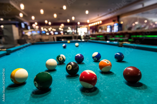 Colorful billiard balls on table in pub