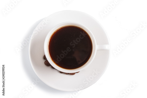 a cup of coffee with coffee beans on a plate, isolated on white. top view.