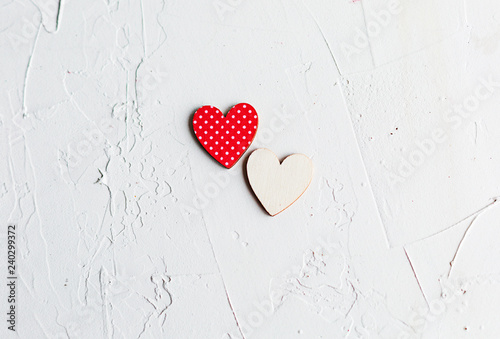 Two wooden decorative hearts on white