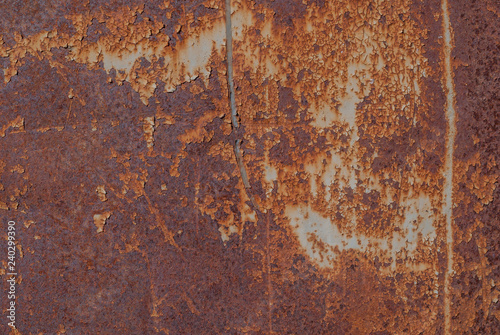 painted iron surface with a large rusty and metal corrosion, old background with peeling and cracking paint as background, orange texture © uvisni