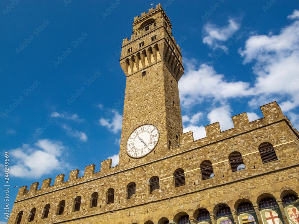 Palazzo Vecchio, the Old Palace in Florence, Italy, partial exterior view from below against a beautiful summer sky