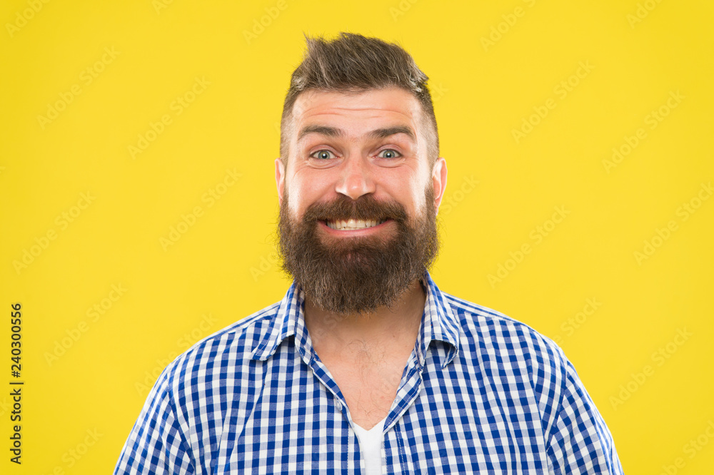 Obraz premium Bearded and happy. Beard fashion and barber concept. Man bearded rustic hipster stylish beard yellow background. Barber tips maintain beard. Stylish beard and mustache care. Hipster appearance