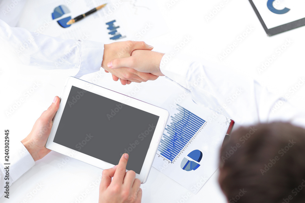 businessman with digital tablet and shaking hands with financial partners