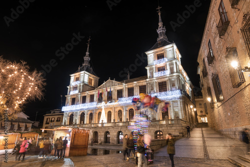 Night scene of Toledo town hall in christmas time, unrecognizable people is in the scene, Toledo, Spain.