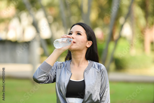 Wallpaper Mural woman drinking water bottle health concept / smiling young girl relax exercise and hold water bottle Torontodigital.ca