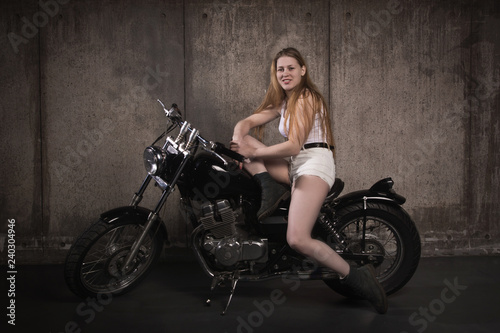 Beautiful biker girl on a motorcycle