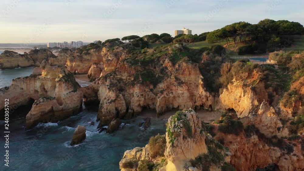 Beautiful aerial flight over rocks and cozy sand beaches Portugal Portimao coastline evening sunset time Beautiful aerial flight over rocks and cozy sand beaches Portugal Portimao coastline evening sunset time