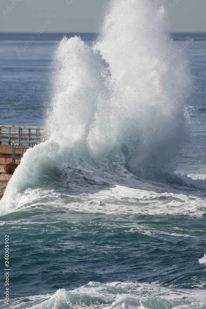 Huge waves crashing over the seawall during storm at La Jolla Cove, San Diego