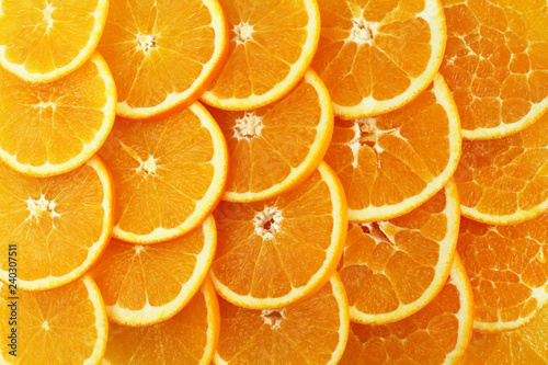 Quadro su tela Food background - slices of ripe orange fruits