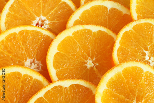 Food background - slices of ripe orange fruits