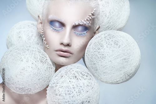 Woman with creative white and blue makeup. Beautiful winter portrait