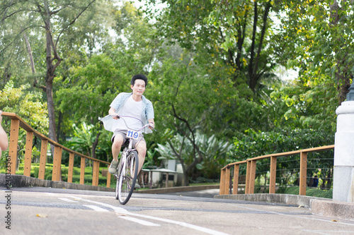 Wallpaper Mural Asian man riding a bicycle for relaxation Torontodigital.ca