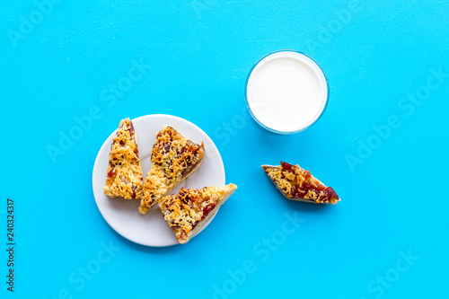 Children tradition evening dessert. Milk and homemade cookies on blue background top view