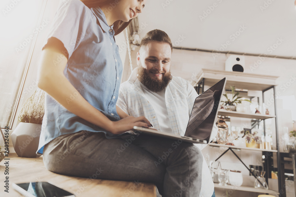 A young girl works at a laptop while sitting A young girl works at a laptop while sitting