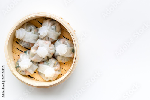 Dim sums with red pepper and vegetables with sticks in Chinese restaurant on white background top view mockup