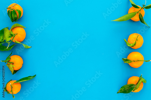 New Year and Christmas Eve with mandarins. Citrus winter fruits on blue background top view space for text