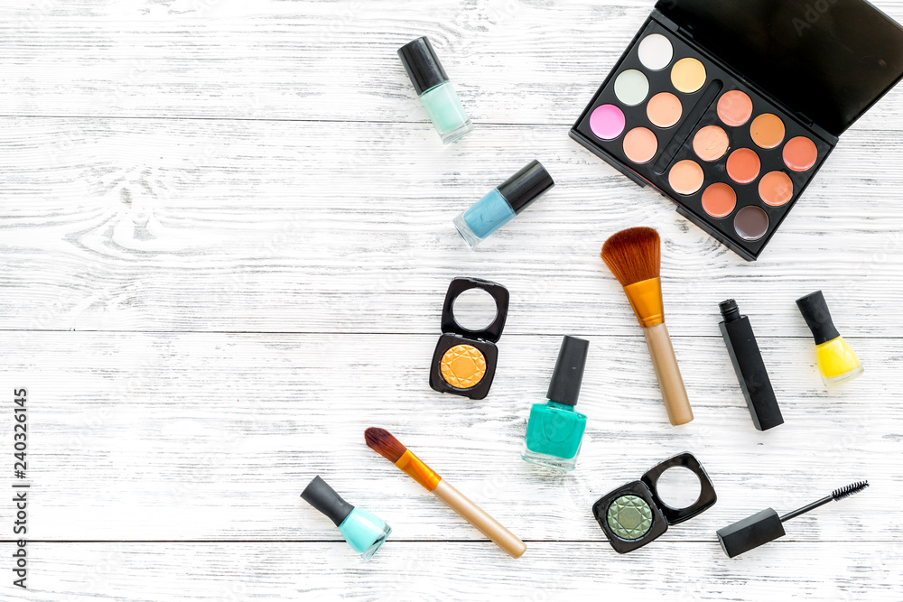 Professional cosmetics set with palette of eyeshadows on gray wooden background top view mock up Professional cosmetics set with palette of eyeshadows on gray wooden background top view mock up