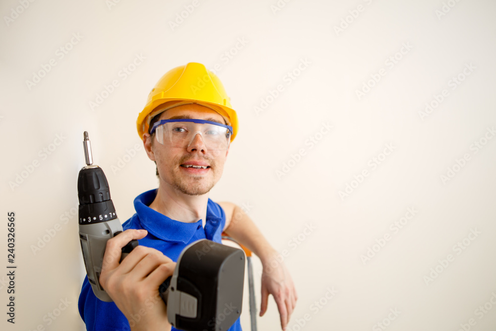 Photo of men with drill and in yellow helmet Photo of men with drill and in yellow helmet