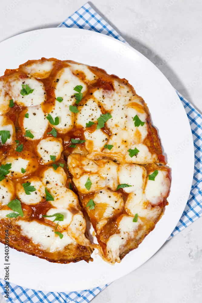 pizza with mozzarella on a white plate, vertical