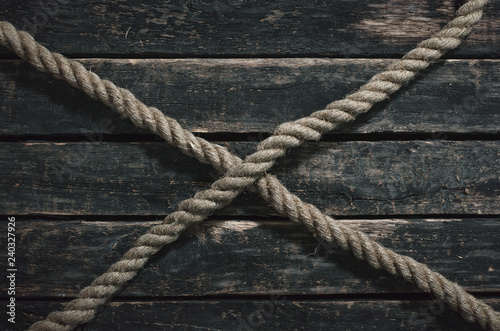 Rope on the wooden surface background.