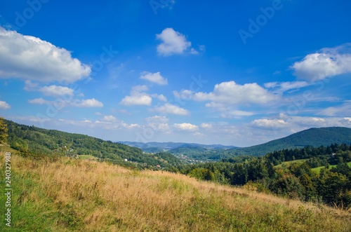 Beautiful rural mountain landscape. Cottages on the hills in the summer scenery.