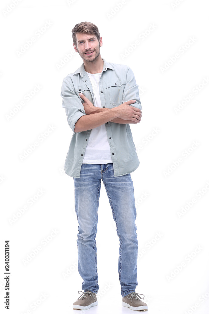 in full growth. smiling young man in jeans in full growth. smiling young man in jeans
