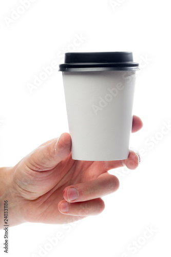 Hand holding paper mug isolated on white