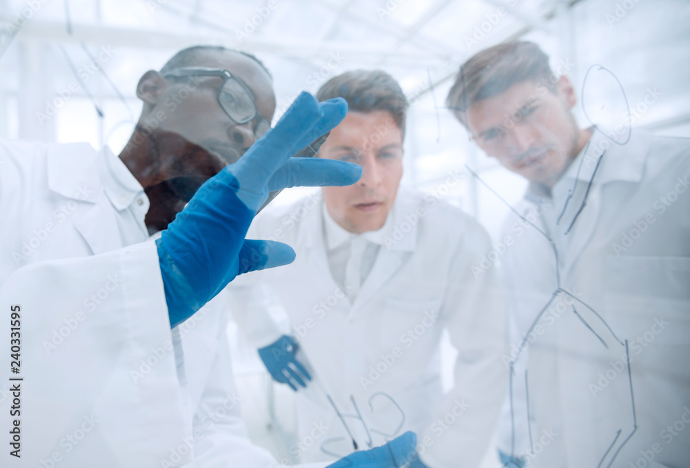 close up.a group of microbiologists discussing new ideas close up.a group of microbiologists discussing new ideas