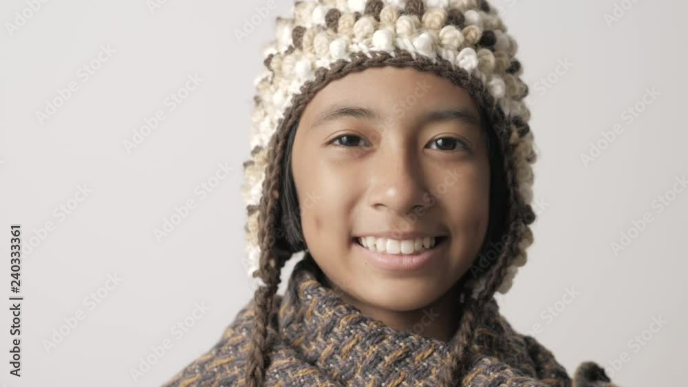 Slow video of an Asian girl smiling on a gray background Slow video of an Asian girl smiling on a gray background