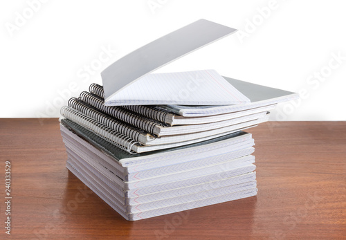 Stack of the different exercise books on wooden table