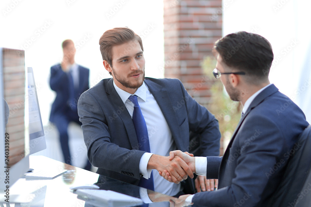 Image of two young businessmen interacting at meeting in office Image of two young businessmen interacting at meeting in office