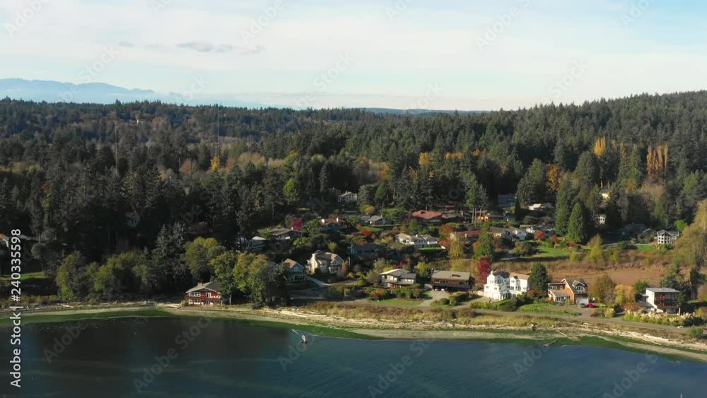 Flying Towards Pacific Northwest Forest Waterfront Neighborhood on Bainbridge Island Washington USA