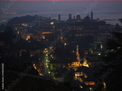 Bergamo, one of the most beautiful city in Italy. Amazing landscape of the old town and the fog covers the plain at sunrise