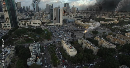 City Under attack in war aerial view Video Compisting simulates Real drone footage with visual effects elements, of Israel Tel aviv city under attack with helicopters smoke and Destroyed buildings. photo