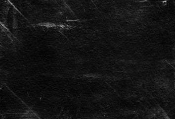 Old black stucco wall with white scratches and scuffs texture. textured grunge black board with chalk