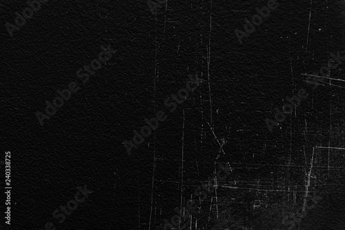 Old black stucco wall with white scratches and scuffs texture. textured grunge black board with chalk