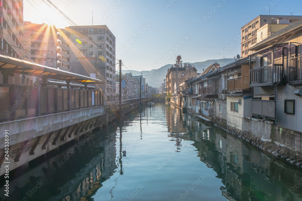 Downtown of Nagasaki city with canal river and sunlight flare, Nagasaki, Kyushu, Japan