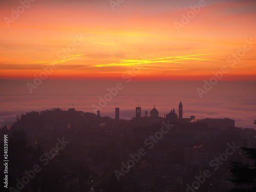 Bergamo  one of the most beautiful city in Italy. Amazing landscape of the old town and the fog covers the plain at sunrise
