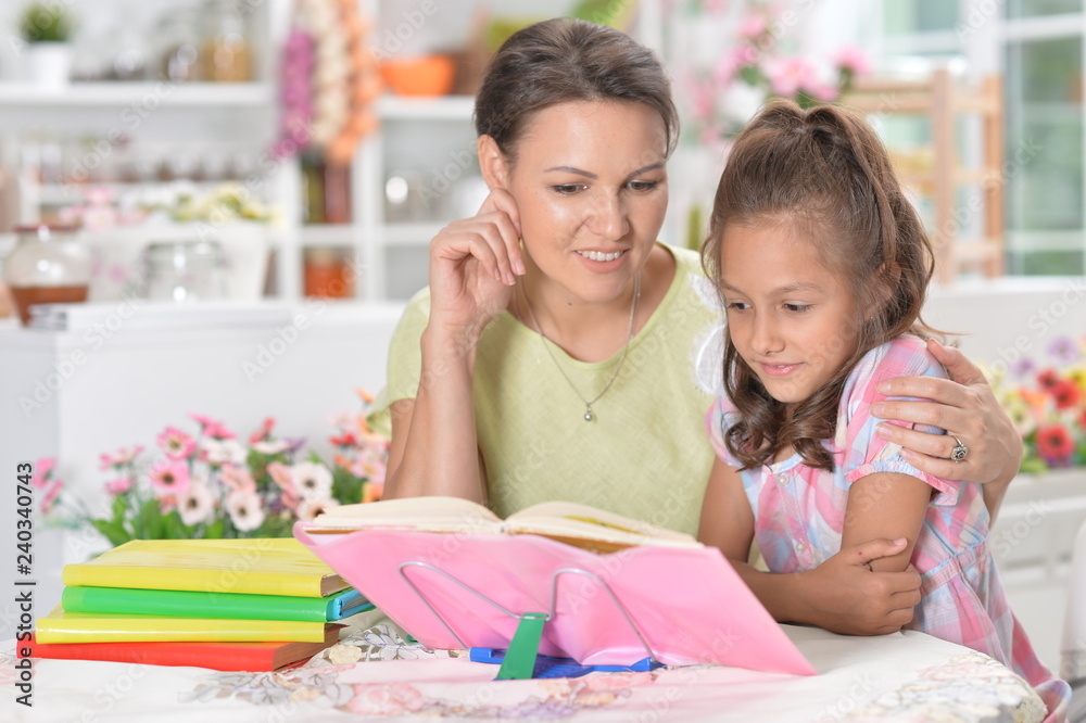 Little girl with her mother doing homework Little girl with her mother doing homework