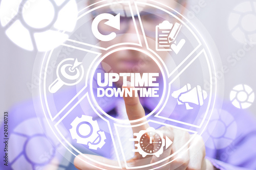 Uptime downtime web business technology concept. Businessman clicks a uptime downtime words button on a virtual modern digital screen. photo