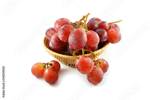 Red grapes out of the refrigerator / Withered begin grapes in basket isolated on white
