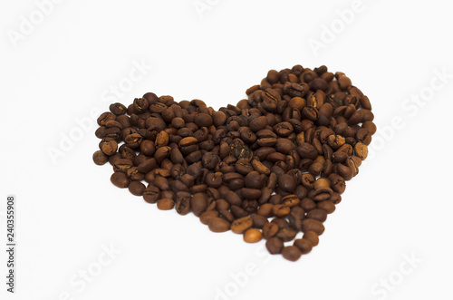 roasted coffee beans lie on a white background in the form of a heart