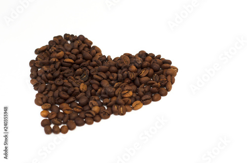 roasted coffee beans lie on a white background in the form of a heart