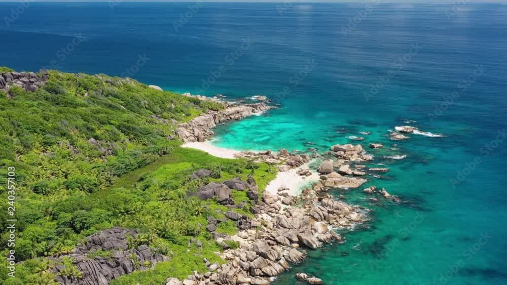 Aerial panoramic view of south coast of La Digue Island, tropical paradise beach with white sand and turquoise crystal clear water of Indian Ocean - Anse Marron, landscape panorama of Seychelles Aerial panoramic view of south coast of La Digue Island, tropical paradise beach with white sand and turquoise crystal clear water of Indian Ocean - Anse Marron, landscape panorama of Seychelles