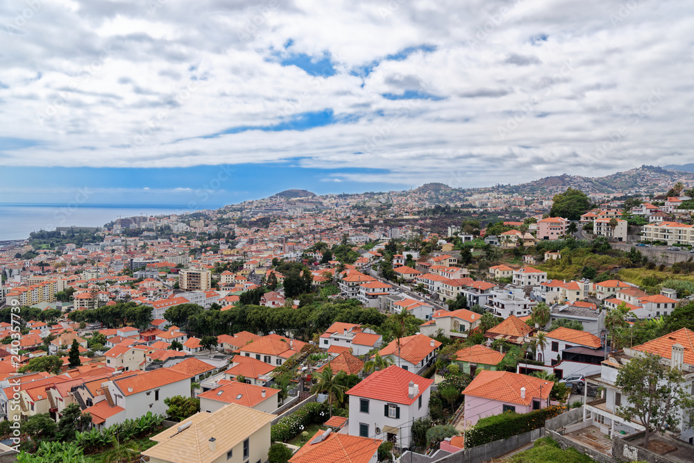 Panorama view at traditional houses against blue cloudy sky on Madeira island